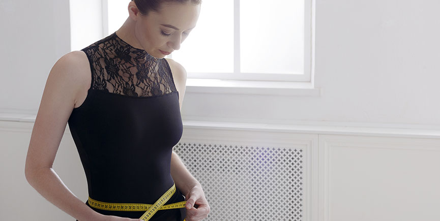 Beautiful ballerine with measuring tape, slim waist after diet