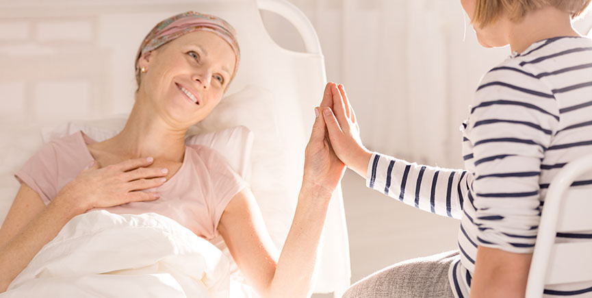 Cancer woman touching child’s hand