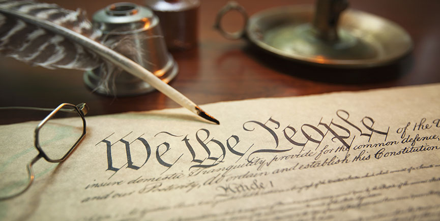 United States Constitution with quill, glasses and candle holder