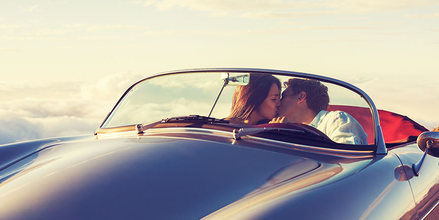 Couple Watching the Sunset in Classic Vintage Car