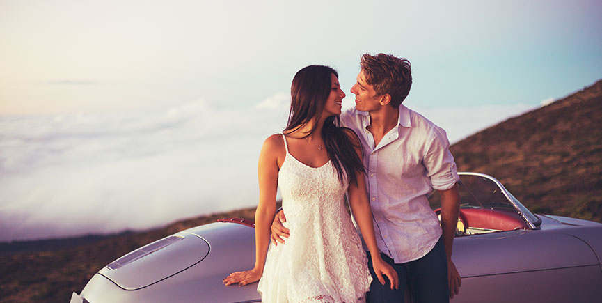 Couple Watching the Sunset with Classic Vintage Car
