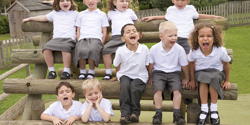 Young children sitting on benches and yelling