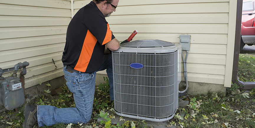 Repairman Checking Outside Air Conditioning Unit For Voltage