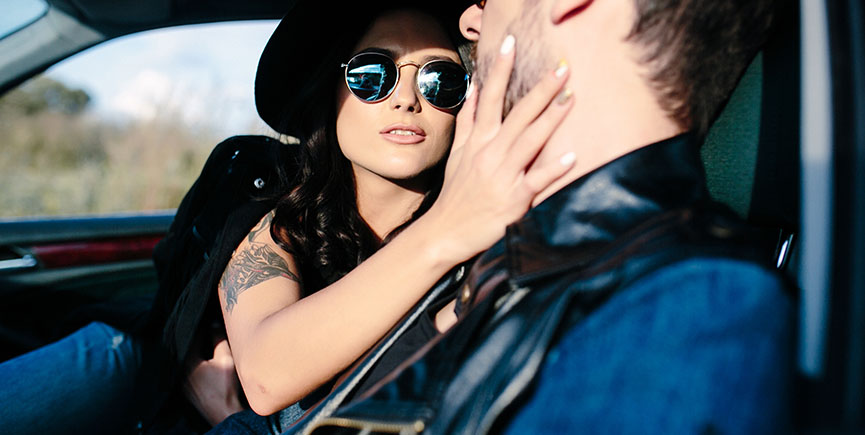 Portrait of young beautiful couple in the car