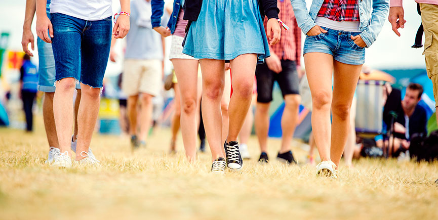 Unrecognizable teenagers, tent music festival, sunny summer, leg