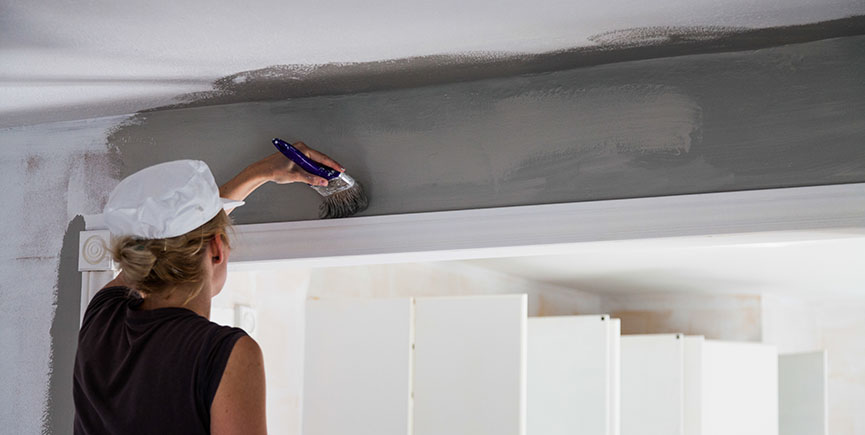 Woman Painting the Edges of the Ceiling